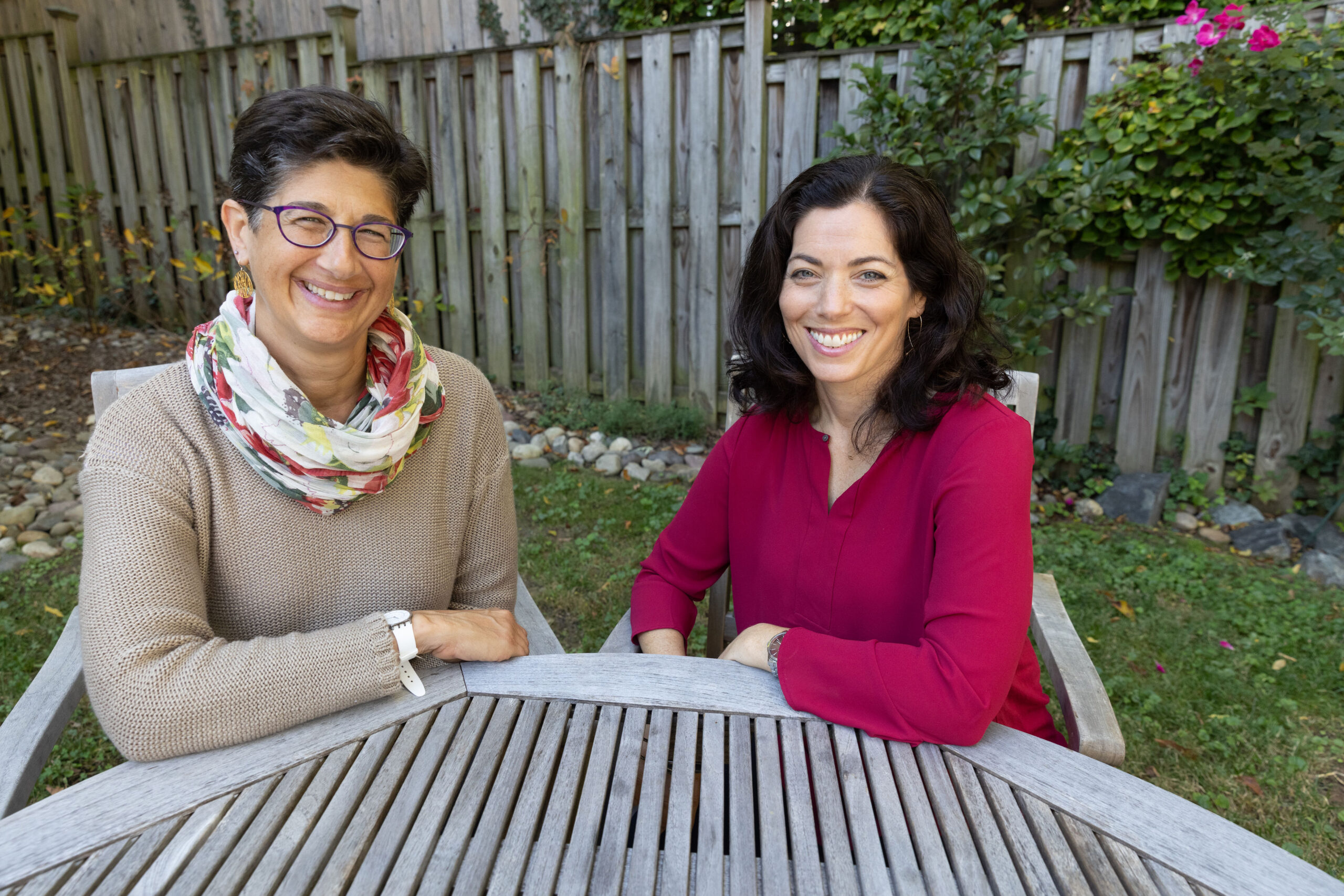 Two dark-haired women smiling at camera
