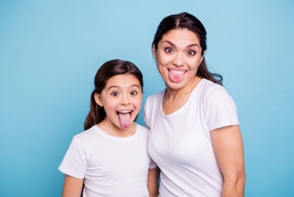 Mom and daughter sticking their tongues out