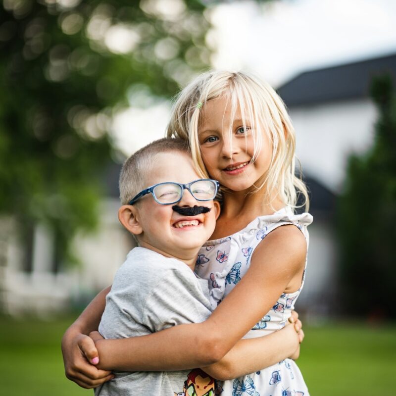 sister hugging her brother, two siblings happy