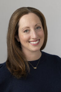 sarah nissim headshot smiling woman with brown hair